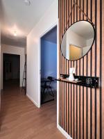 a mirror on a wall next to a hallway at SSP Suites- Cosy &amp; Bel appartement 4 pièces 3 chambres 90M2 avec balcon in Épinay-sur-Seine