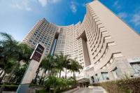 a large building with palm trees in front of it at Radisson Alphaville in Barueri