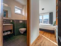 a bathroom with a toilet a sink and a bed at Grebenzen Lodge Prinz in Sankt Lambrecht