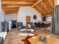 an open living room with a table and chairs at Grebenzen Lodge Prinz in Sankt Lambrecht