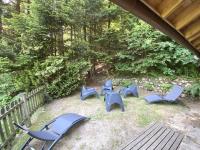 a group of blue chairs sitting in the grass at LE GRAND CERF Chalet en rondins avec SPA Jacuzzi in La Bresse