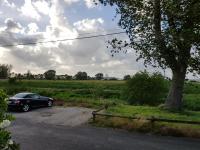 a car parked in a parking lot next to a field at Aux Rives de Honfleur in Berville-sur-Mer