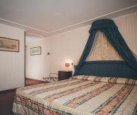 a bedroom with a large bed with a canopy at Hotel Kette in Venice