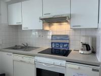 a kitchen with white cabinets and a counter top at 501 - Appartement 1 chambre à Erquy, à proximité du port, en bordure de la plage du centre in Erquy