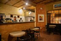 a restaurant with four tables and a counter in a room at Villa del Cielo in Tilcara