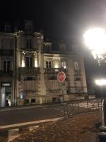 a stop sign in front of a building at night at L&#39;aristide in Épinal