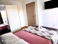Posteľ alebo postele v izbe v ubytovaní Apartman Roso