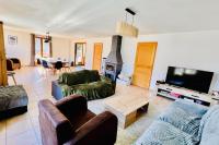 a living room filled with furniture and a flat screen tv at Pretty triplex with garden and view in Puy-Saint-Pierre