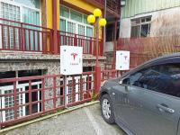 a car parked next to a fence next to a building at Kingtaiwan Hotel in Lugu Lake
