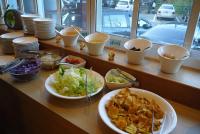 a buffet with bowls of food on a counter at Kingtaiwan Hotel in Lugu Lake