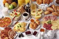 a table with a bunch of different types of breakfast foods at Skiathos Holiday Resort in Skiathos