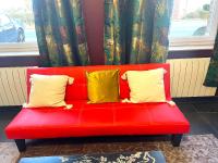 a red couch with two yellow pillows on it at La Domus Lemaitre 1, plain-pied, Wifi , TV, parking, jardin 