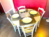 a table with white plates and wine glasses on it at La Domus Lemaitre 1, plain-pied, Wifi , TV, parking, jardin 
