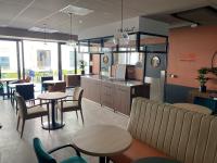 een restaurant met 2 tafels en stoelen en een bar bij CAZAM Paris Saint Ouen in Saint-Ouen