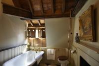 a bathroom with a bath tub and a toilet at The Rookery in London