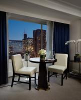 a dining room with a table and chairs and a window at The Peninsula Chicago in Chicago