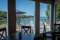 a dining room with a view of the water at Smuggler's Cove Inn in Boothbay