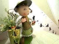 a statue of a doll with flowers in a room at 萩閣民宿Sara&#39;s House走路可到夜市近市區好停車 in Hualien City