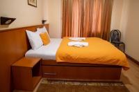 a bedroom with a bed with two towels on it at Hotel Pepa in Divčibare