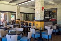 a restaurant with tables and chairs and a bar at Hotel Pepa in Divčibare