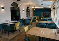 a dining room with tables and chairs in a restaurant at Hotel Pepa in Divčibare