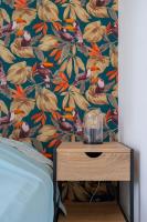 a bedroom with a bed and a table with a flower wallpaper at Maison avec jardin &quot;les Néréïdes&quot; port et plage de la Pointe Rouge Marseille in Marseille