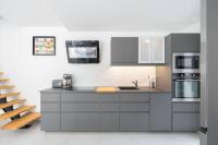 a kitchen with gray cabinets and a sink at Maison avec jardin &quot;les Néréïdes&quot; port et plage de la Pointe Rouge Marseille in Marseille