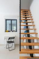 a wooden spiral staircase in a room with a chair at Maison avec jardin &quot;les Néréïdes&quot; port et plage de la Pointe Rouge Marseille in Marseille