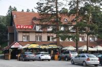 a building with cars parked in front of it at Hotel Pepa in Divčibare