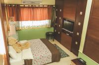 a bedroom with a teddy bear sitting on a bed at Zhong Shan 330 in Hualien City