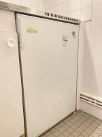 a white refrigerator in a kitchen with a sign on it at Super appartement 3T proche Tour Eiffel in Paris