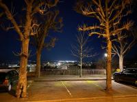 a group of trees in a parking lot at night at Location saisonnière Angoulême in Angoulême