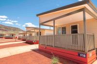a row of houses with a porch on a street at Tom Price Tourist Park in Tom Price