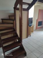 a wooden staircase in a room with a tv at Casa del Sol in Arónion