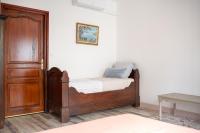 a bedroom with a bed and a wooden door at Au Nid de la Madeleine in Gaillac