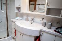 a bathroom with a white sink and a shower at Appartement Mountainrelax Gastein in Dorfgastein