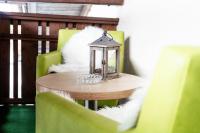 a table with a lantern on a green chair at Appartement Mountainrelax Gastein in Dorfgastein