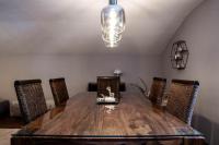 a dining room table with chairs and a light fixture at Appartement Mountainrelax Gastein in Dorfgastein