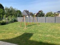 a park with a swing set in the grass at LE COQ - Maison 10 personnes - Locmariaquer in Locmariaquer