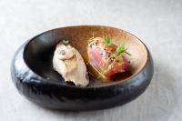 a bowl of food with meat and vegetables on it at La Mansion Vi Vadi Hotel in Munich