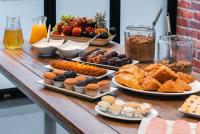 a table with different types of pastries and other foods at Cape Diamond Boutique Hotel in Cape Town