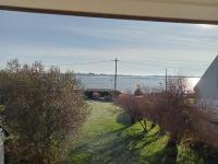 a view of the water from the window of a house at Parenthese relaxante les pieds dans l eau in Le Tour-du-Parc