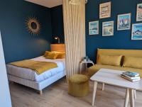 a bedroom with a bed and a couch at GLAZIK - Studio - Lumineux - Parking in Vannes