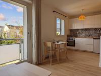 a kitchen with a table and chairs and a window at GLAZIK - Studio - Lumineux - Parking in Vannes