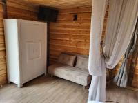a room with a couch in a log cabin at Bastide De Mazan in Riez