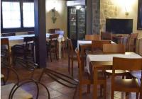 a dining room with tables and chairs and a tv at El Valle Hotel Rural in Sotillo del Rincón