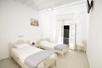 A bed or beds in a room at Dimitra Pension