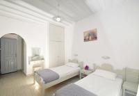 A bed or beds in a room at Dimitra Pension
