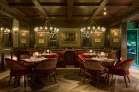 a restaurant with tables and chairs and chandeliers at Todos Santos Boutique Hotel in Todos Santos