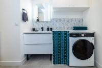 a washing machine in a kitchen with a sink at Le CosyNaï - 20min to Paris in Sannois